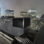 Industrial generator on building roof top in city